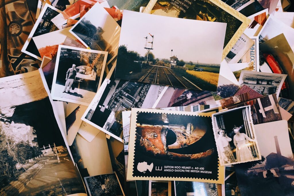 a pile of old photos and postcards sitting on top of each other